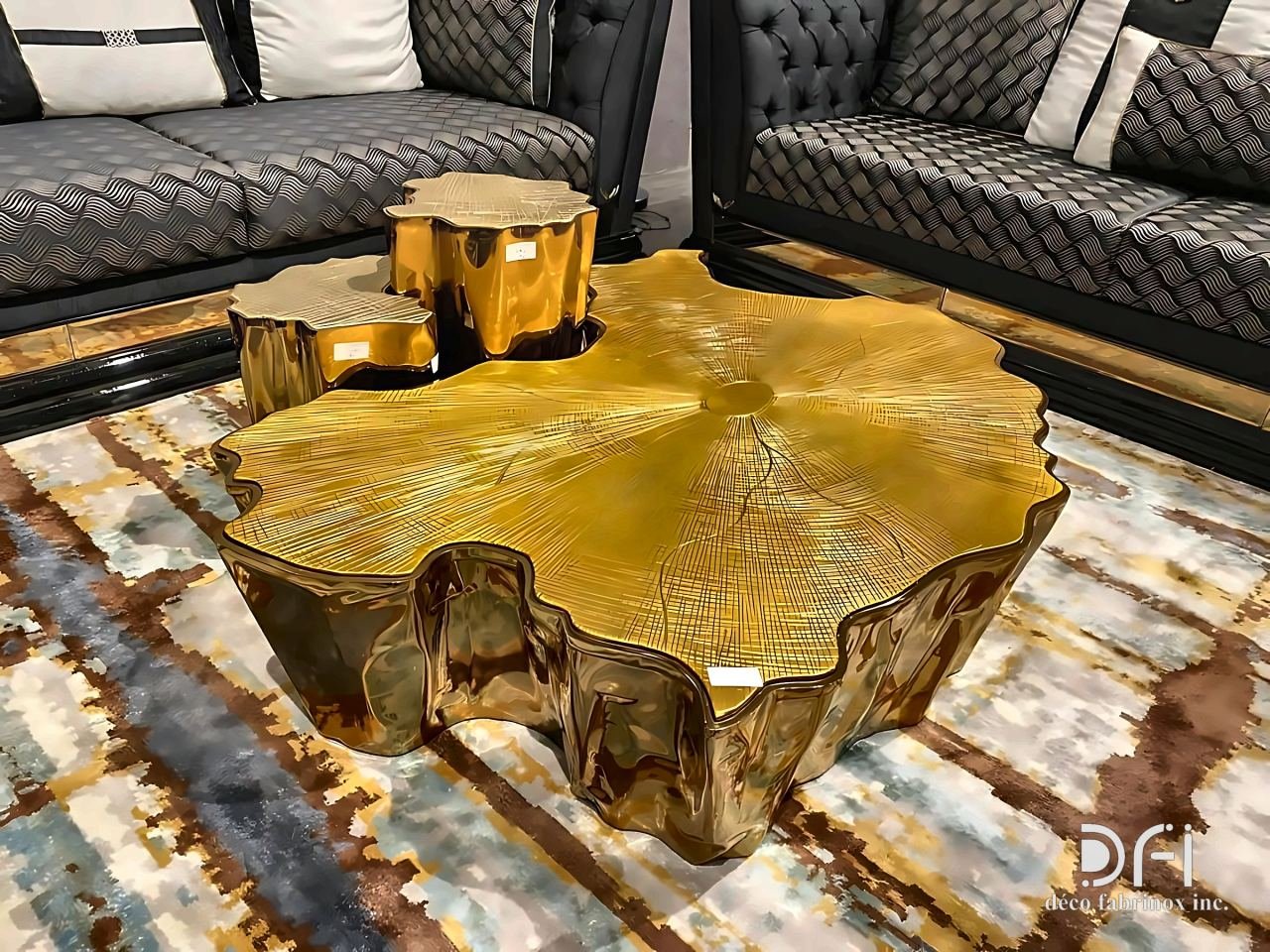 Gold cast-metal centre table shaped like a cut tree trunk, with matching side tables