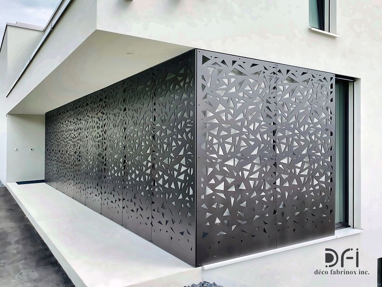 Laser-cut black metal facade screen on a building corner