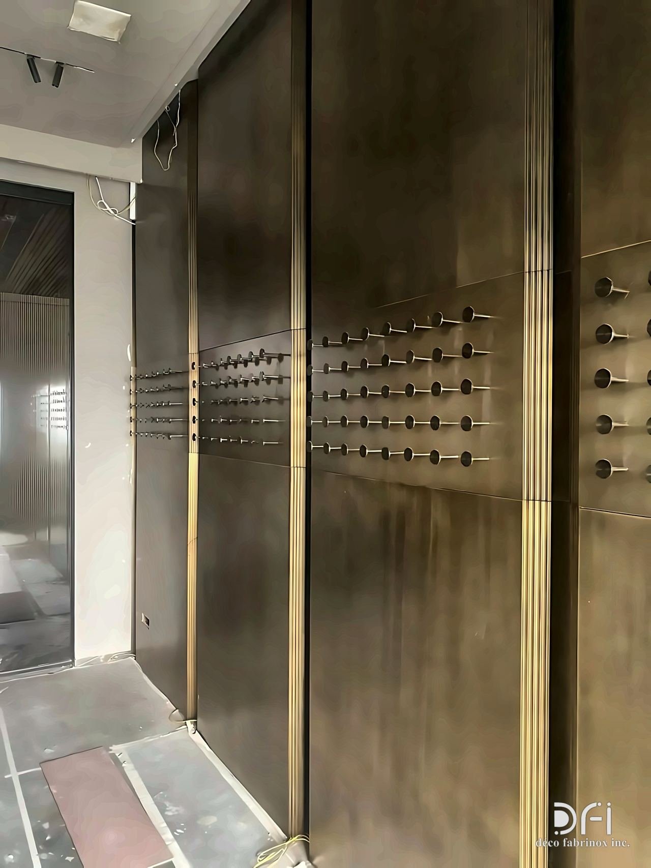 Antique bronze wall cladding with studded panels