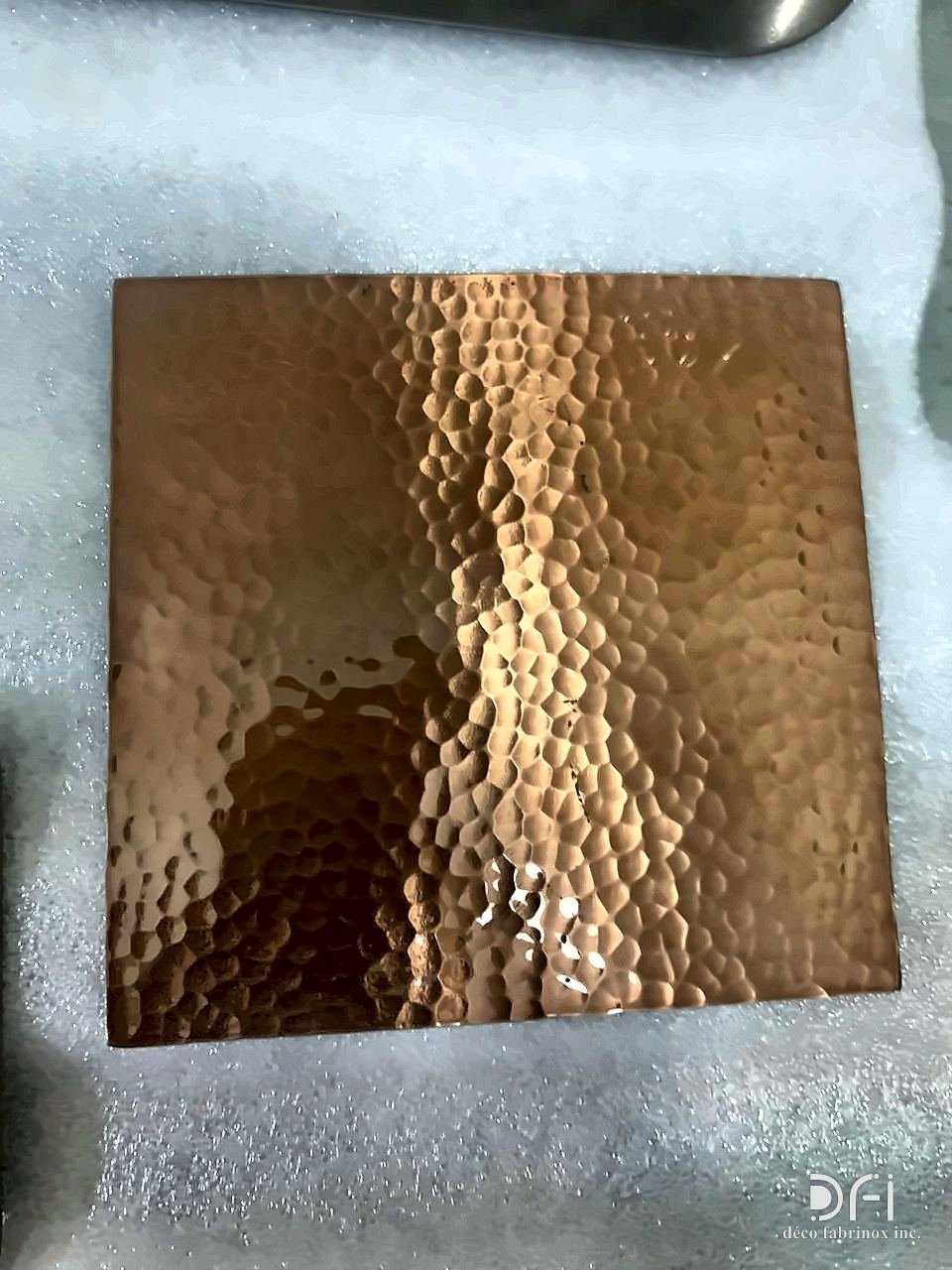 Hammered copper finish sample with a dimpled surface